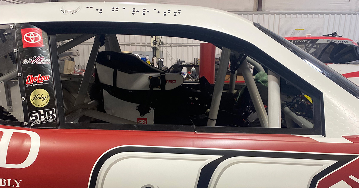 photo of name "C. Garrett" spelled in Braille over passenger side door of Colin Garrett's race car